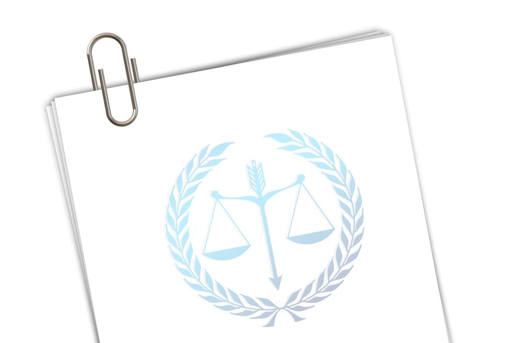A graphic of a casefile with the scales (justice) logo. Image by Gerd Altmann from Pixabay.